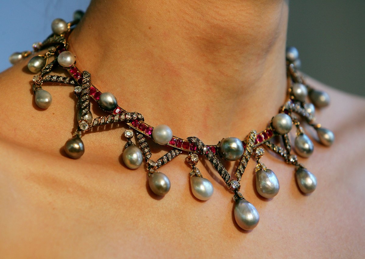 A Christie's employee models a pearl, diamond, and ruby necklace owned by the Dukes of Sutherland ahead of an upcoming auction in 2007 (Cate Gillon/Getty Images)