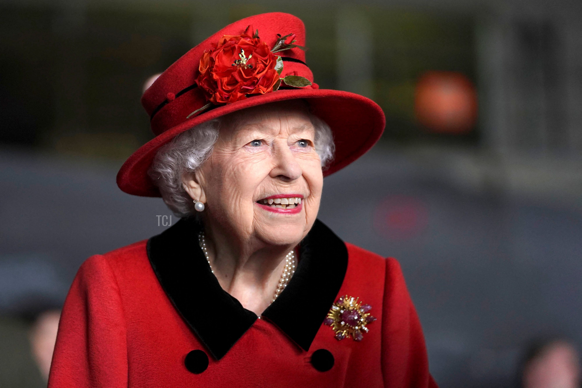Queen Elizabeth II reacts as she meets military personnel during her visit to the aircraft carrier HMS Queen Elizabeth in Portsmouth, southern England on May 22, 2021