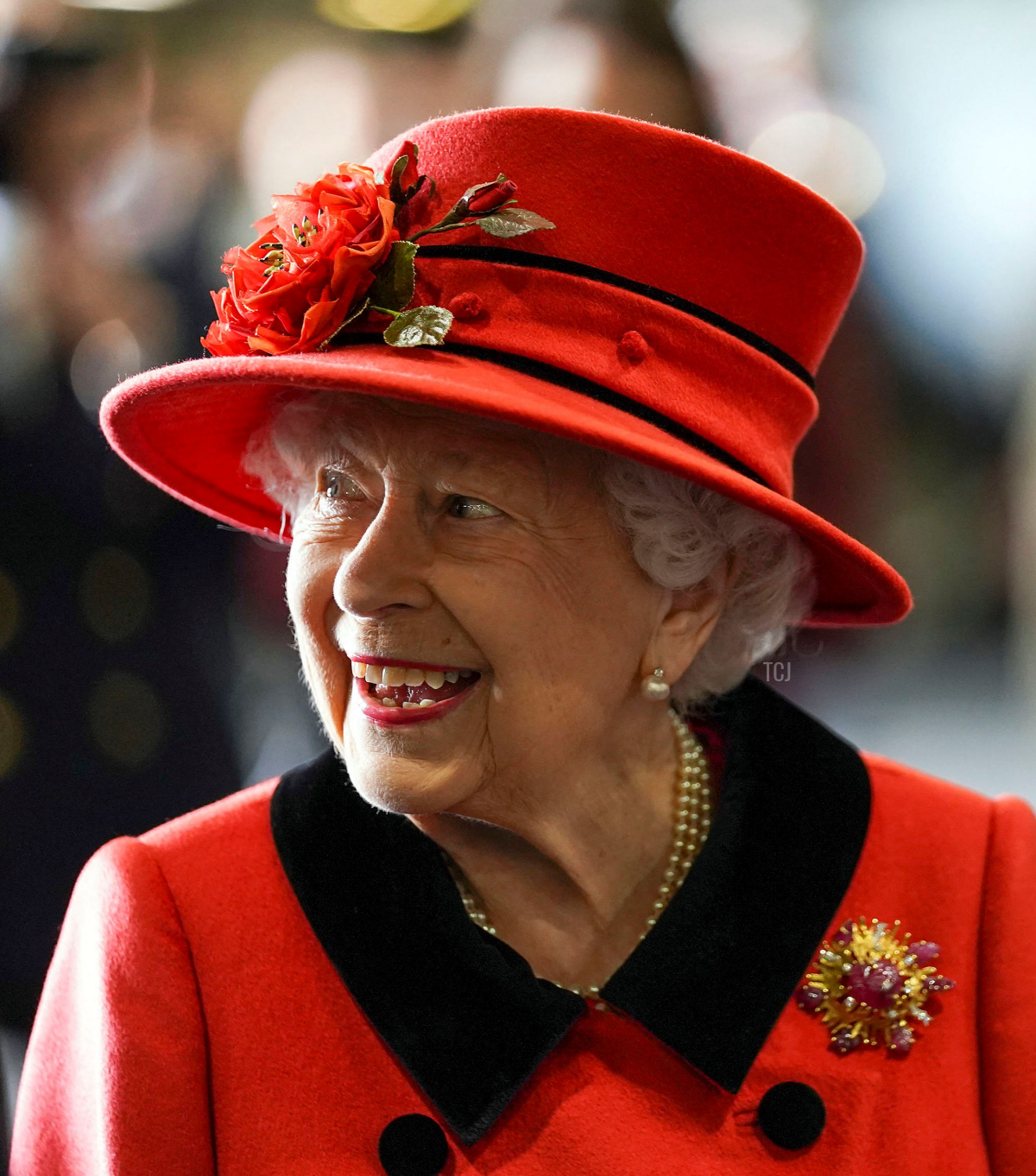 Queen Elizabeth II reacts as she meets military personnel during her visit to the aircraft carrier HMS Queen Elizabeth in Portsmouth, southern England on May 22, 2021