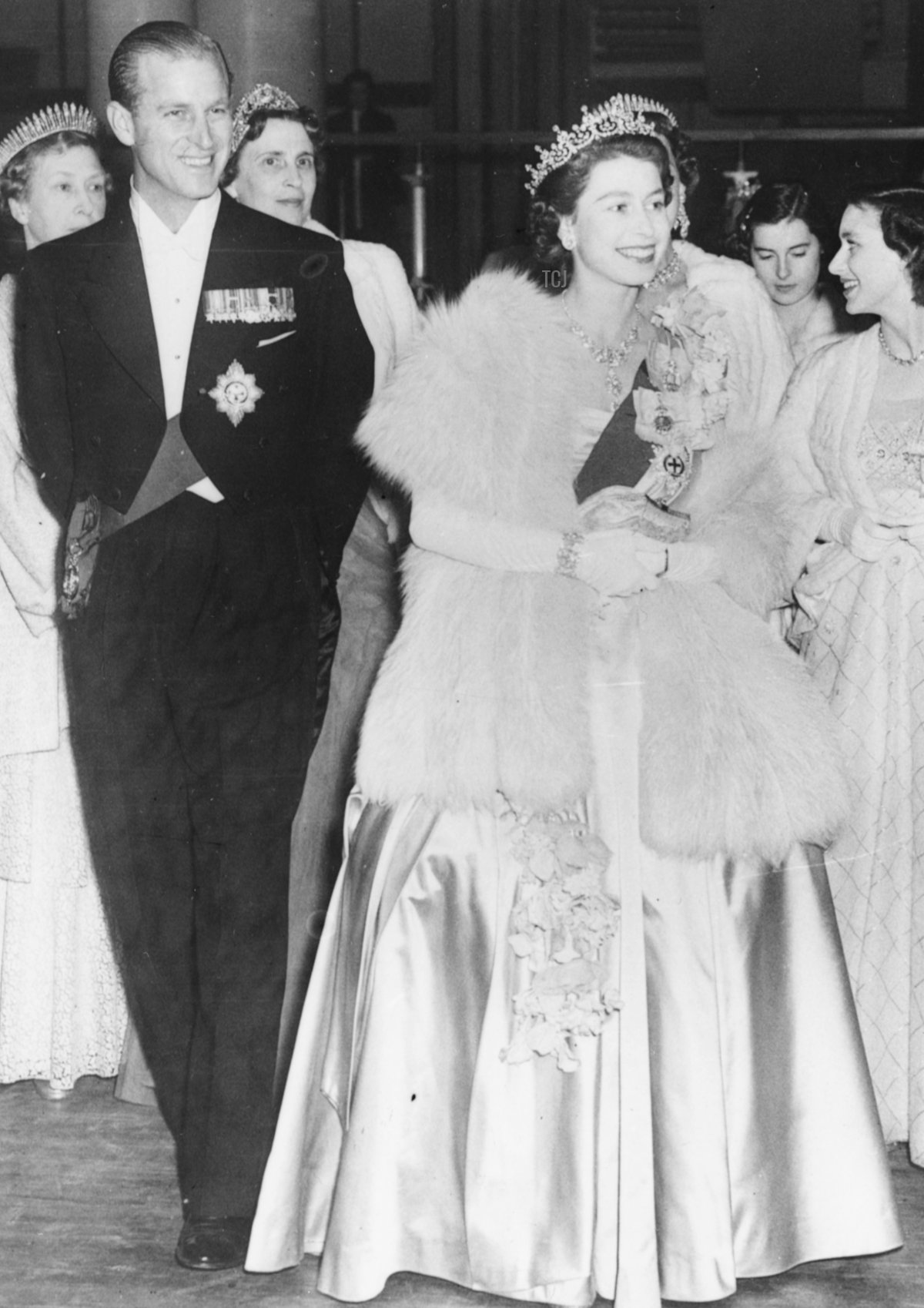 HM Queen Elizabeth II and Prince Philip, the Duke of Edinburgh, wearing formal dress as they attend a concert at Festival Hall, London, May 1951