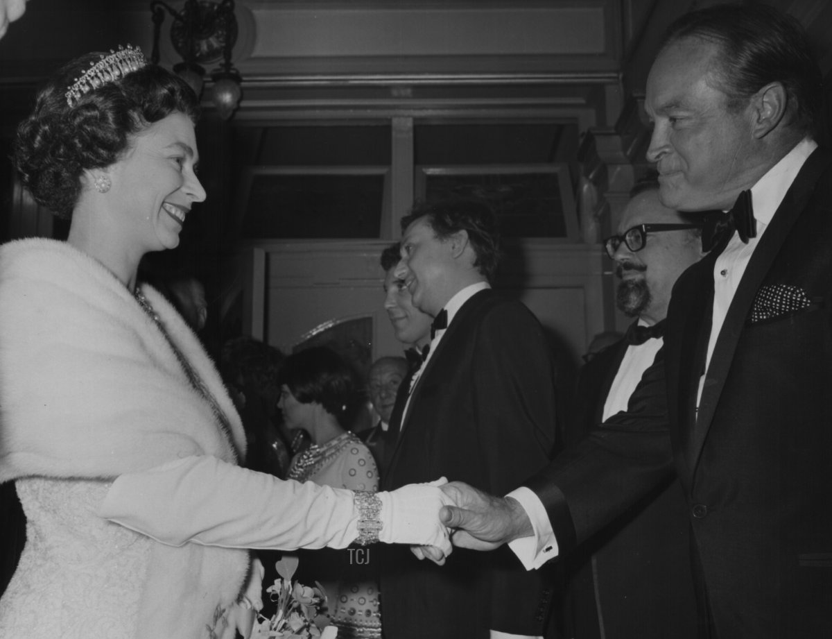 Queen Elizabeth II shaking hands with Bob Hope, with Mireille Mathieu, Ken Dodd and Harry Secombe in the background, at the Royal Variety Performance, London Palladium, November 13th 1967