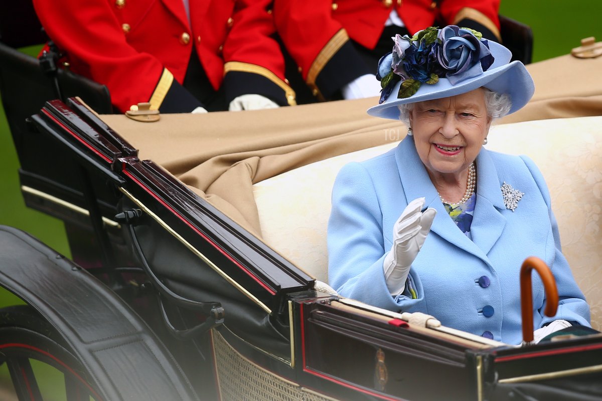 Queen Elizabeth II waves to the crowds as she arrives on day one of Royal Ascot at Ascot Racecourse on June 18, 2019 in Ascot, England