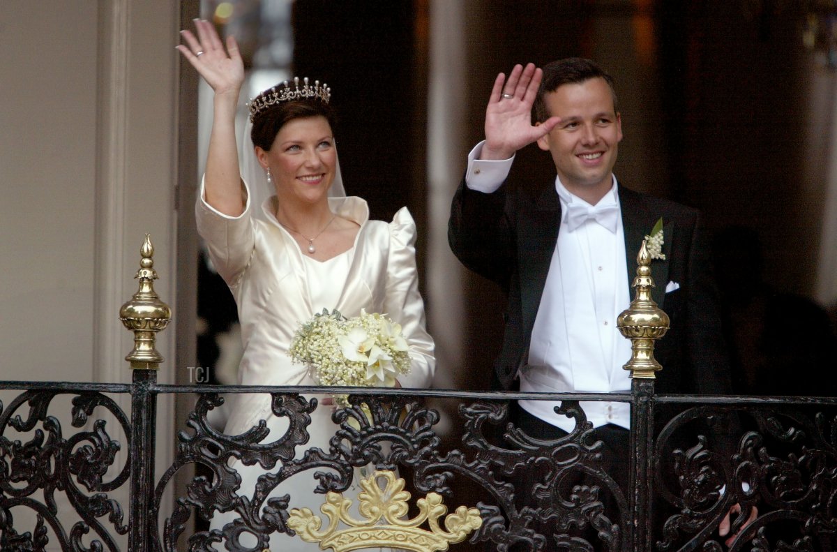 Princess Martha Louise of Norway and writer Ari Behn wave from the balcony of the Stiftsgarden Palace after their wedding at the Nidaros Cathedral May 24, 2002 in Trondheim, Norway