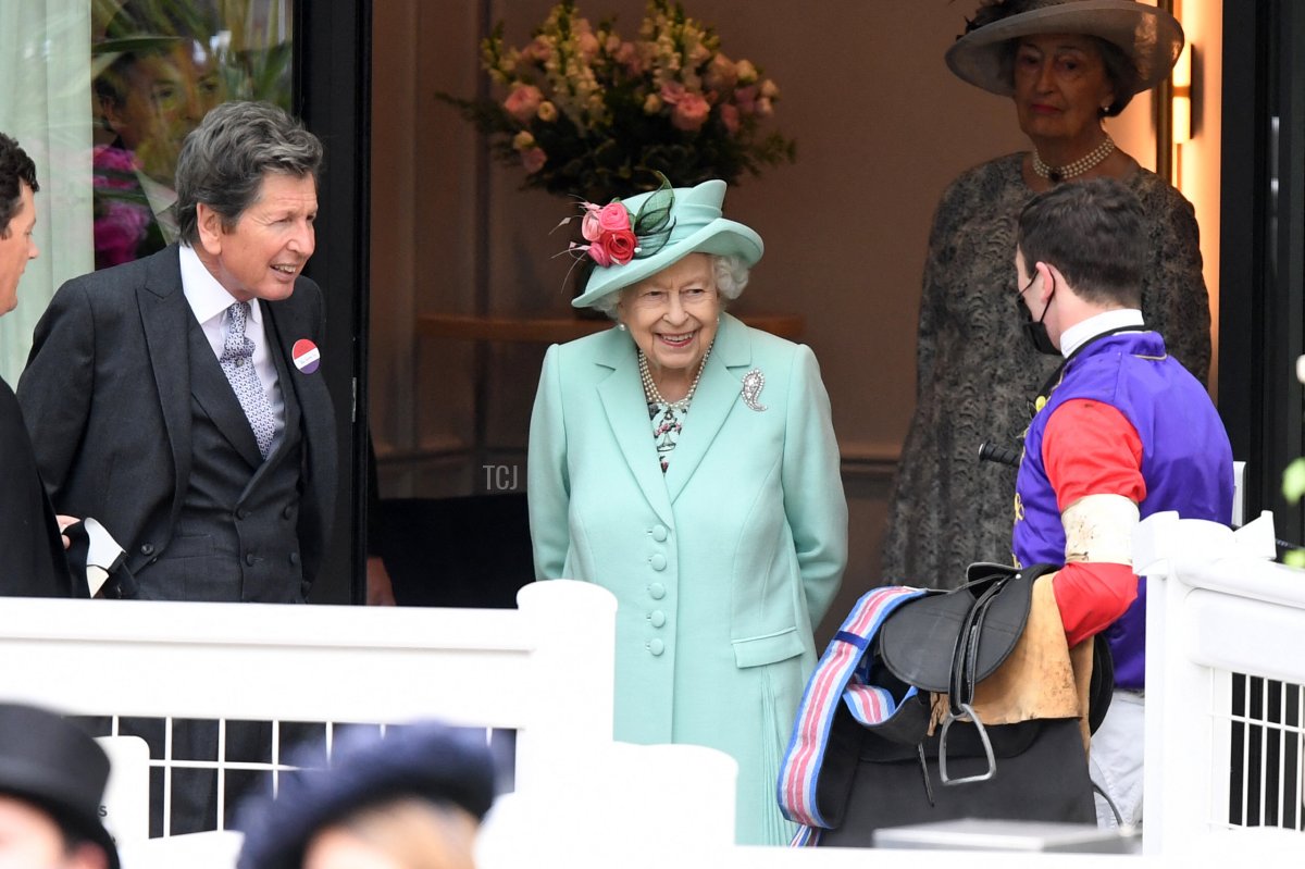 Britain's Queen Elizabeth II smiles as she meets a jockey on the fifth day of the Royal Ascot horse racing meet, in Ascot, west of London on June 19, 2021