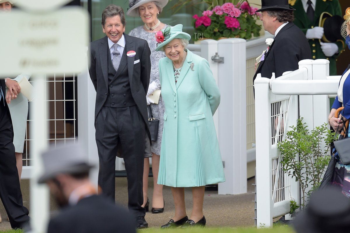Queen Elizabeth II (C) and John Warren (L) watch as horses are led into the parade ring during Royal Ascot 2021 at Ascot Racecourse on June 19, 2021 in Ascot, England