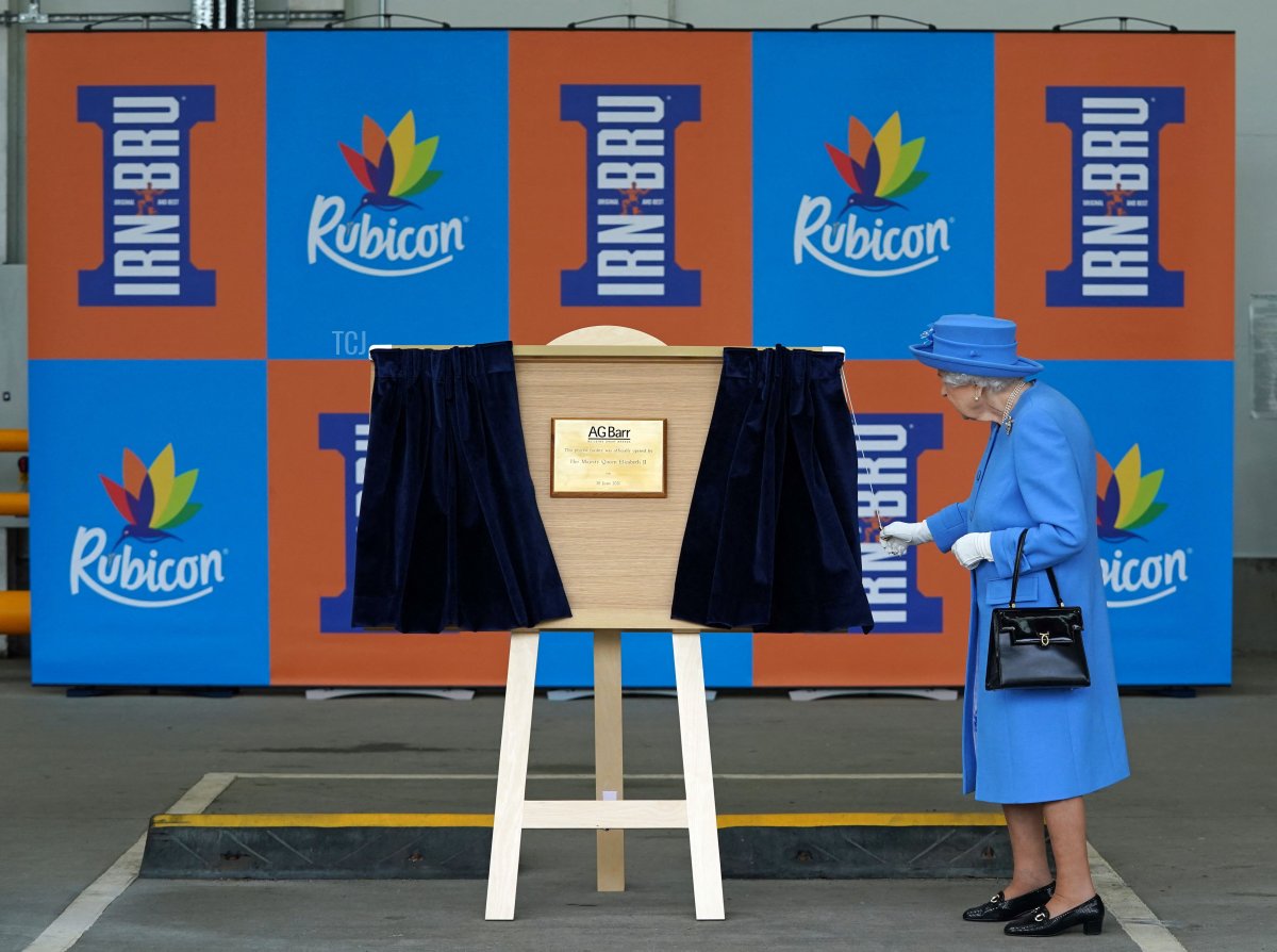 Britain's Queen Elizabeth II unveils a plaque during a visit to AG Barr's factory in Cumbernauld, east of Glasgow, where the Irn-Bru drink is manufactured on June 28, 2021