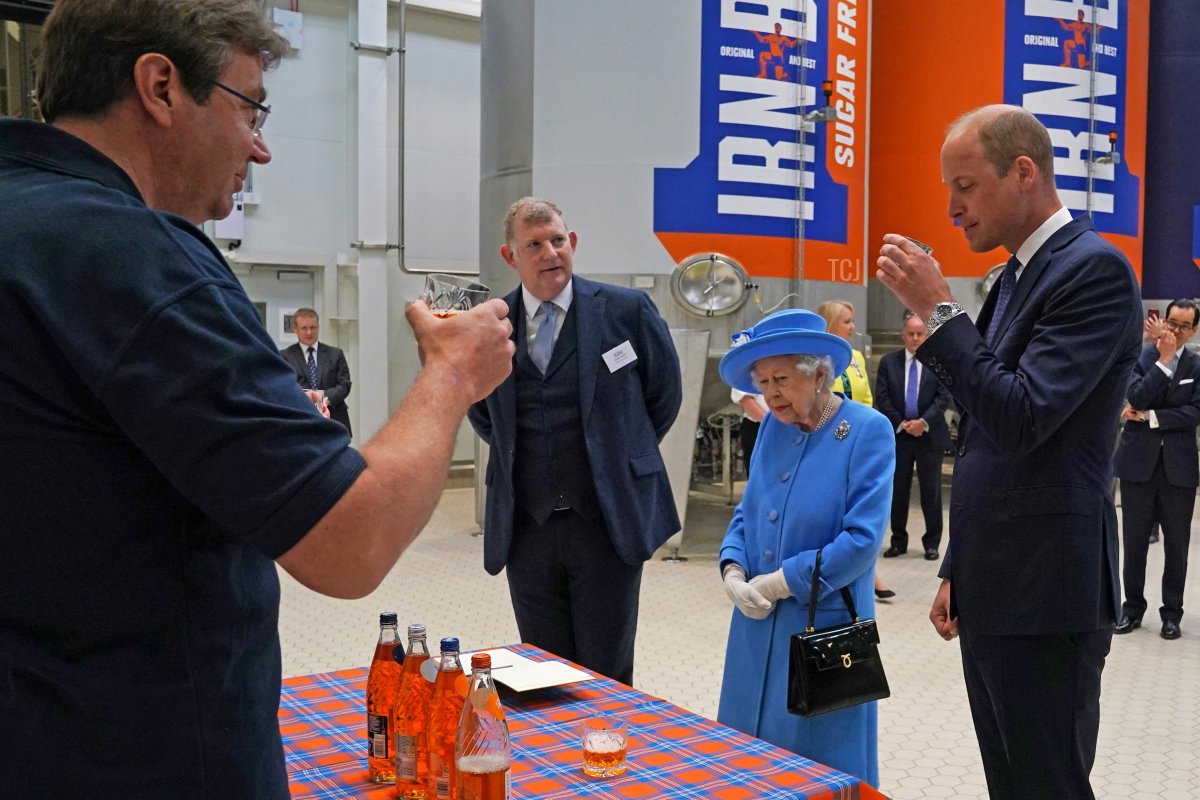 Britain's Prince William, Duke of Cambridge (R) samples Irn-Bru as he and Britain's Queen Elizabeth II visit AG Barr's factory in Cumbernauld, east of Glasgow, where the Irn-Bru drink is manufactured on June 28, 2021