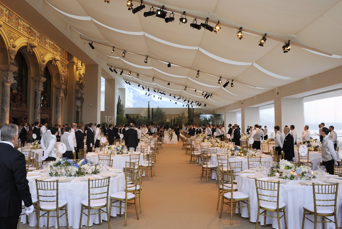 A picture shows waiters working at the Opera Terraces before the dinner following the religious wedding ceremony of Prince Albert II of Monaco and Princess Charlene of Monaco on July 2, 2011 in Monaco