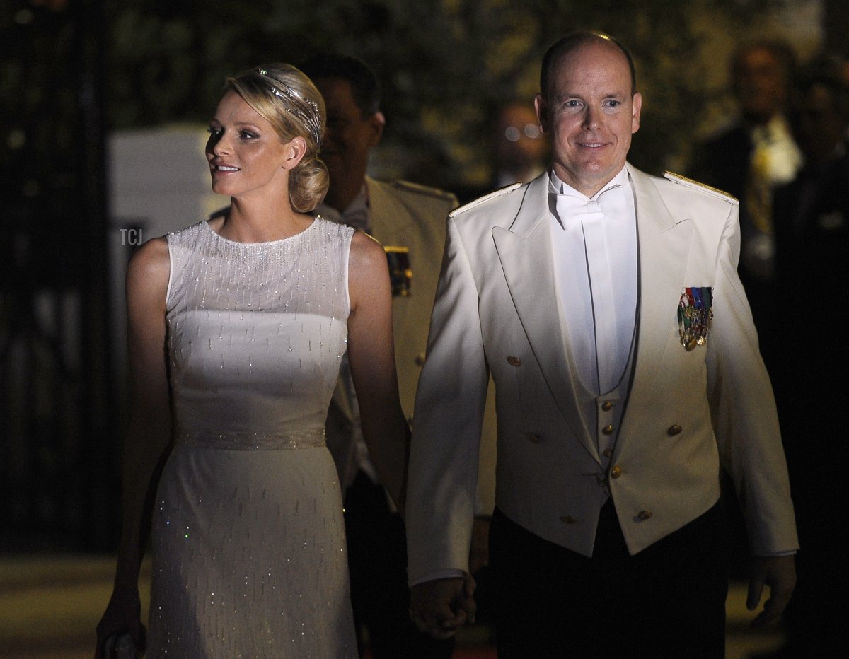 Princess Charlene of Monaco and Prince Albert II of Monaco arrive for a dinner at Opera terraces after their religious wedding ceremony on July 2, 2011 in Monaco