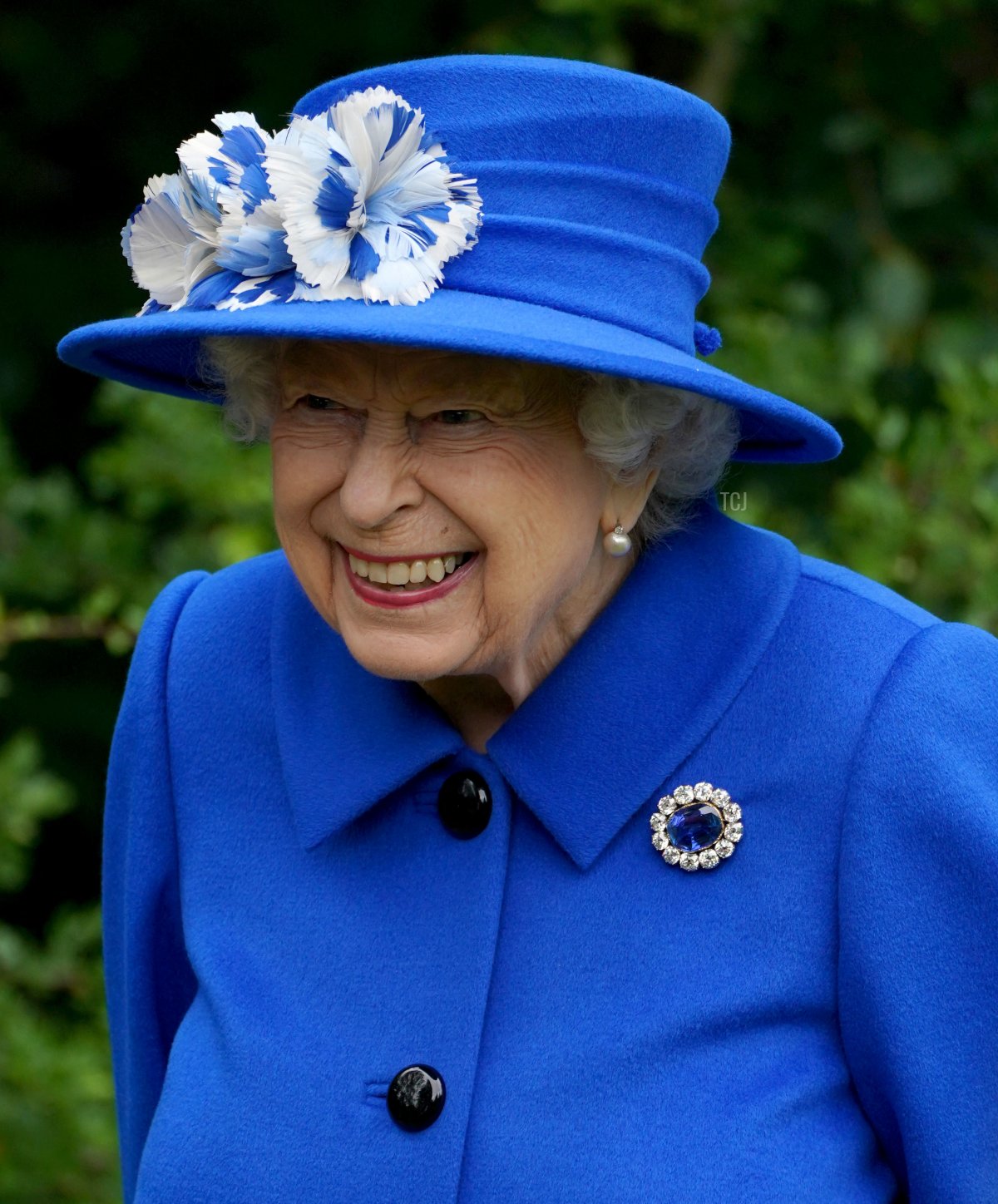Britain's Queen Elizabeth II gestures as she meets participants during a visit to The Childrens Wood Project in Glasgow on June 30, 2021, as part of her traditional trip to Scotland for Holyrood Week