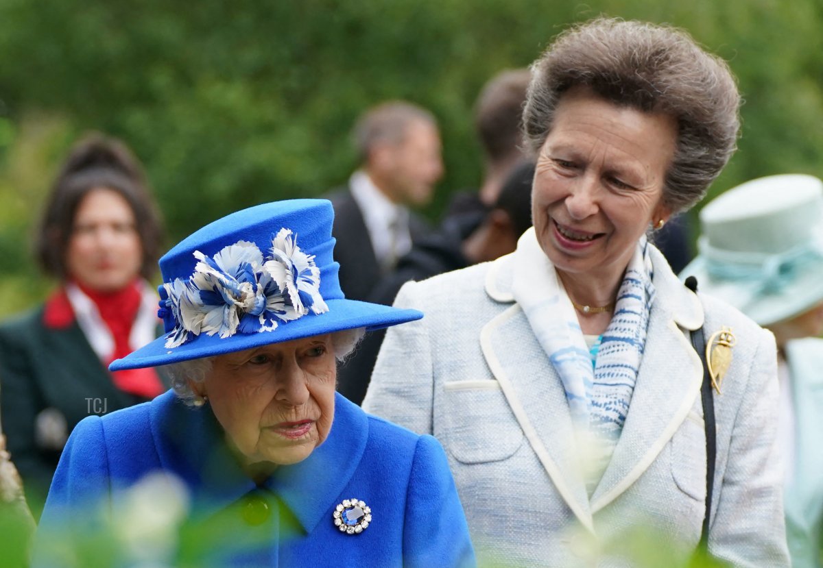 Britain's Princess Anne, Princess Royal speaks to Britain's Queen Elizabeth II during a visit to The Childrens Wood Project in Glasgow on June 30, 2021, as part of her traditional trip to Scotland for Holyrood Week