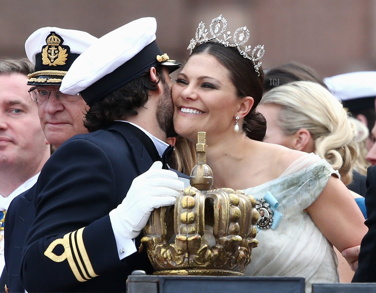 Prince Carl Philip of Sweden places one hand on the crown as he chats with his sister, Crown Princess Victoria of Sweden, after his marriage ceremony to Princess Sofia, at The Royal Palace on June 13, 2015 in Stockholm, Sweden