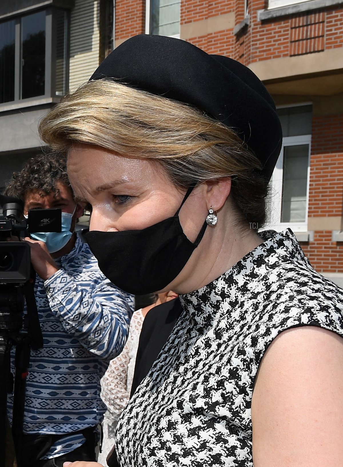 Queen Mathilde of Belgium (R) talks with residents during a tribute ceremony with a minute of silence, part of the national mourning day for victims of the severe floods, in Verviers on July 20, 2021