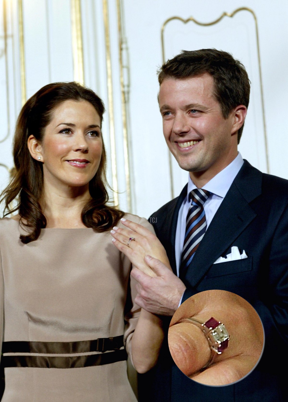 Danish Crown Prince Frederik shows the engagement ring on the hand of his fiancee Mary Donaldson of Australia 08 October 2003 during their first joint press conference at the royal palace of Fredensborg north of Copenhagen after the official announcement