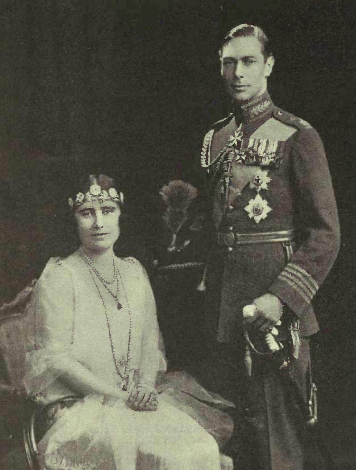 Portrait photograph of Prince Albert, Duke of York (later to be King George VI) in the full dress uniform of an RAF group captain and his bride, Elizabeth Bowes-Lyon, in 1927