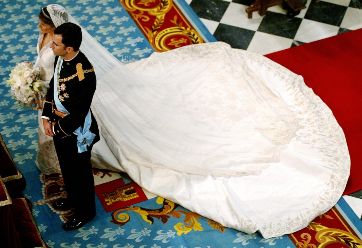 Spanish Crown Prince Felipe (R) and the Princess of Asturias Letizia Ortiz stand as they get ready to place Ortiz's bridal bouquet at Madrid's Basilica of Atocha May 22, 2004