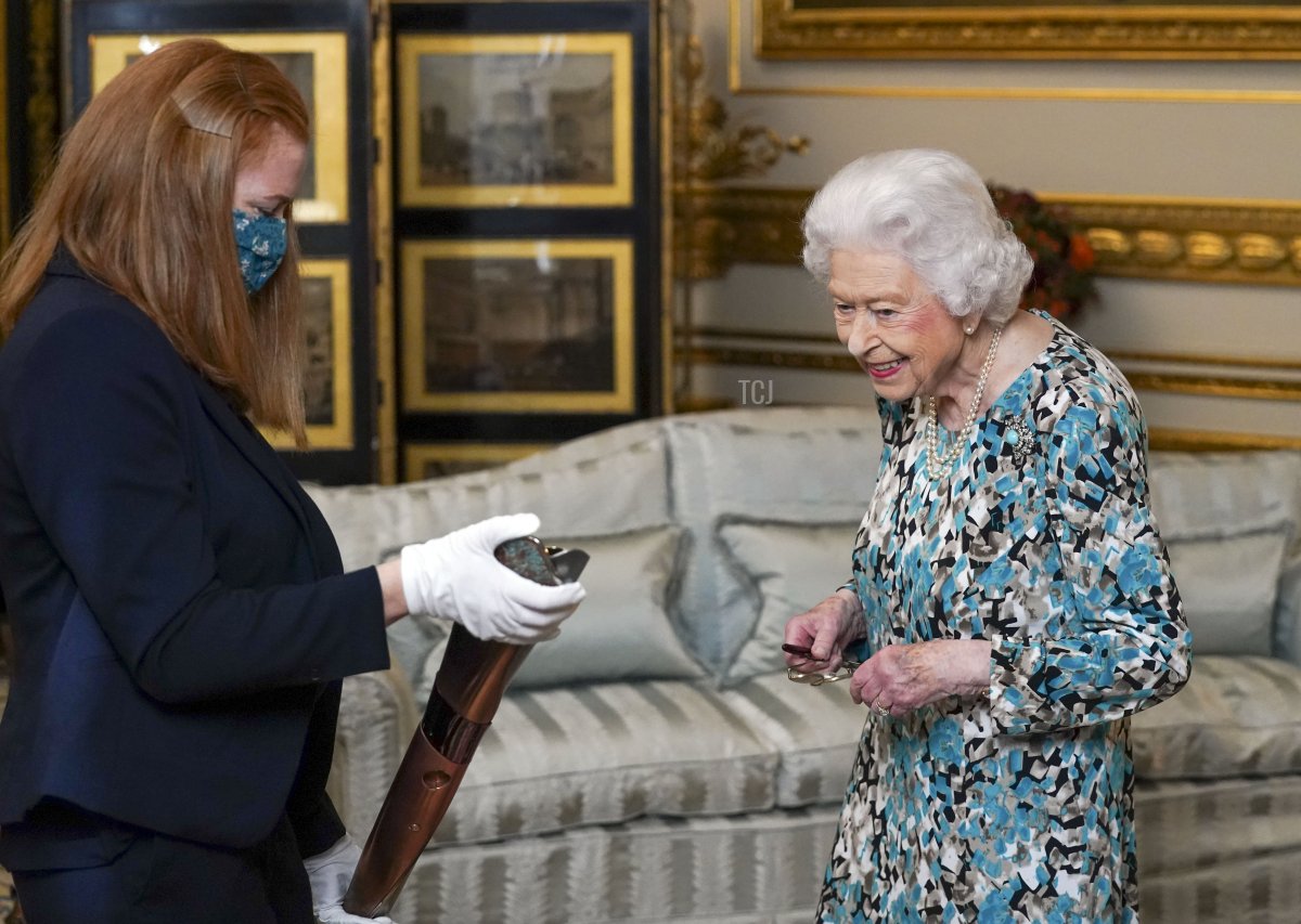 Queen Elizabeth II looks at the Birmingham 2022 Commonwealth Games Baton during the Baton Relay for Birmingham 2022, the XXII Commonwealth Games at Buckingham Palace on October 7, 2021 in London, England