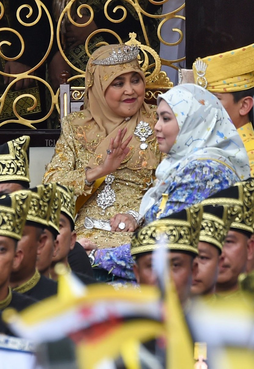 Brunei's Sultan Hassanal Bolkiah (center-L) and Queen Saleha (centre-R) wave from the royal chariot during a procession to mark his golden jubilee of accession to the throne in Bandar Seri Begawan on October 5, 2017