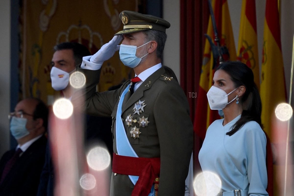 Spain's Prime Minister Pedro Sanchez (L), King Felipe VI of Spain (C) and Queen Letizia of Spain (R) attend the Spanish National Day military parade in Madrid on October 12, 2021