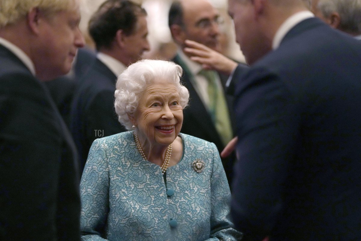 Britain's Queen Elizabeth II and Prime Minister, Boris Johnson greet guests during a reception for international business and investment leaders at Windsor Castle to mark the Global Investment Summit on October 19, 2021 in Windsor, England