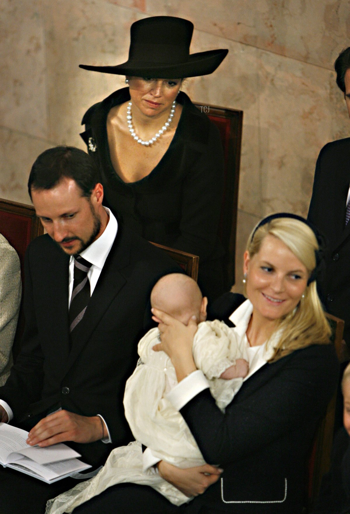 Norwegian Prince Sverre Magnus (C) sits ins his mothers, Crown Princess Mette-Marit's (R) arms as his father Crown Prince Haakon (L) and his god mother Princess Maxima (2L) of The Netherlands is look on during the baptism ceremony in the Chapel at the Royal Palace in Oslo 04 March 2006