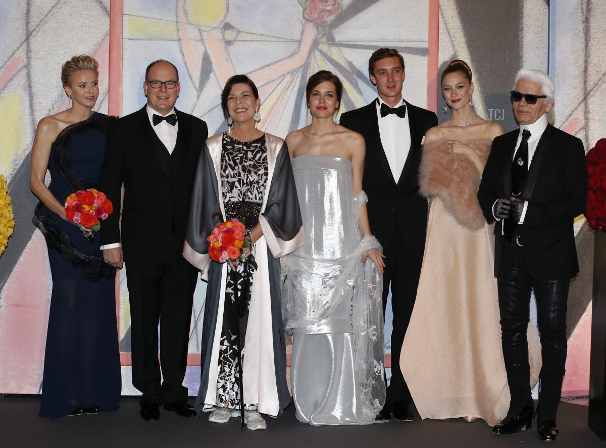 Princess Charlene of Monaco, Prince Albert II of Monaco, Princess Caroline of Hanover, Charlotte Casiraghi, Pierre Casiraghi and his girlfriend Beatrice Borromeo, and German fashion designer Karl Lagerfeld pose as they arrive for the annual Rose Ball at the Monte-Carlo Sporting Club in Monaco, on March 29, 2014