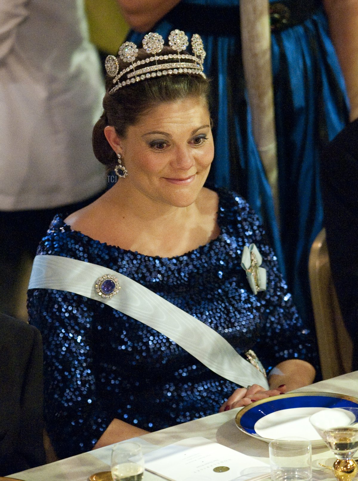 Swedish Crown Princess Victoria reacts at the honorary table during the Nobel banquet following the Nobel Prize award ceremony held at the Stockholm Town Hall on December 10, 2011
