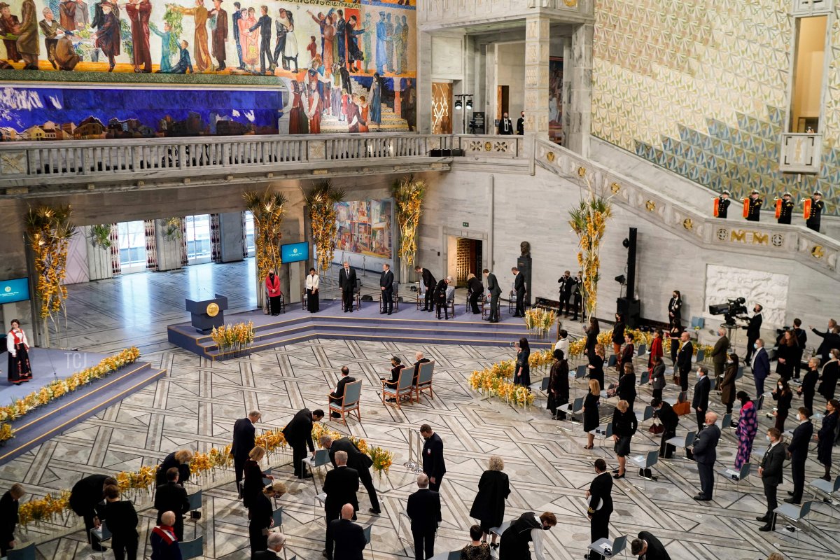 Overall view taken as spectators stand in social distancing prior to the gala award ceremony for the Nobel Peace prize for journalists Maria Ressa (2ndL on stage) of the Philippines and Dmitry Muratov (3rdL on stage) of Russia on December 10, 2021 in Oslo