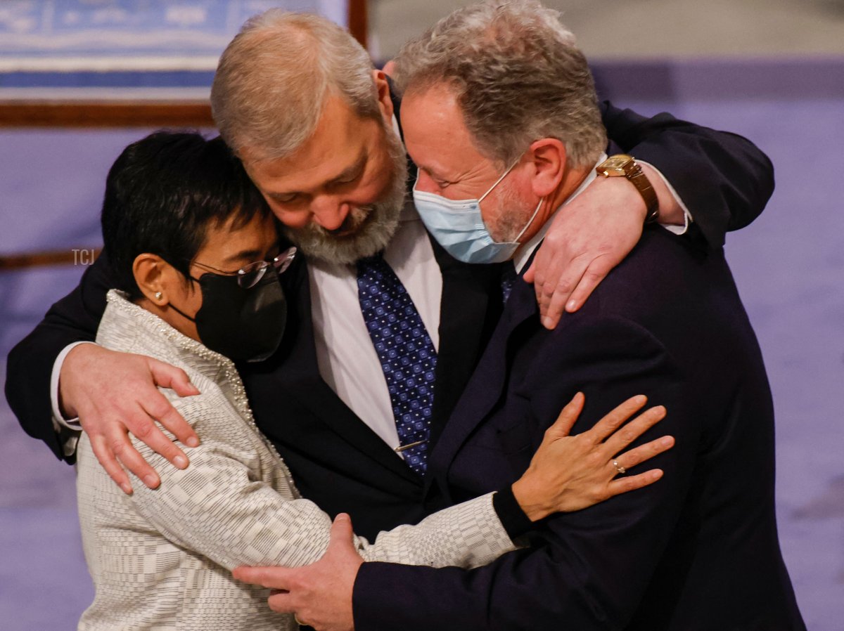 Nobel Peace Prize laureate Maria Ressa of the Philippines (L), Nobel Peace Prize laureate Dmitry Muratov of Russia (C) and 2020 Nobel Peace Prize laureate David Beasley of the World Food Program hug after the gala award ceremony for the Nobel Peace prize on December 10, 2021 in Oslo
