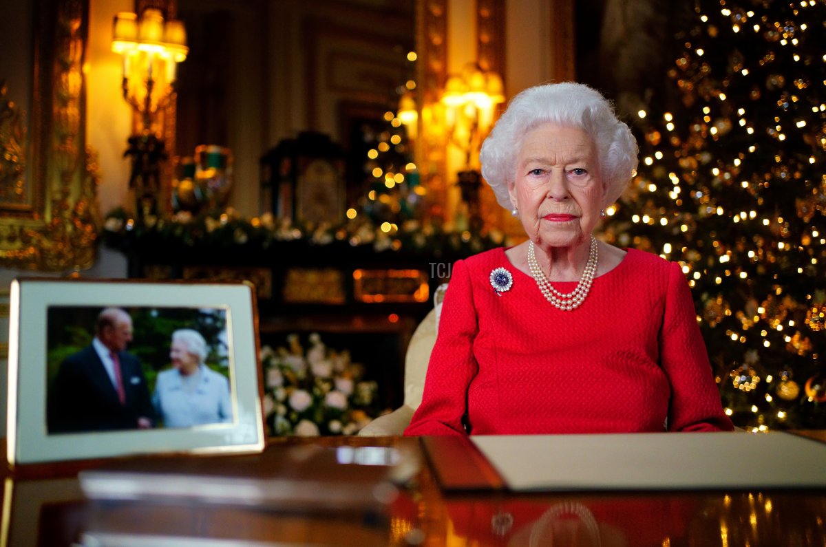 Queen Elizabeth II records her annual Christmas broadcast in the White Drawing Room at Windsor Castle on December 23, 2021 in Windsor, England. The photograph on the desk is of The Queen and the Duke of Edinburgh, taken in 2007 at Broadlands, Hampshire, to mark their Diamond Wedding Anniversary