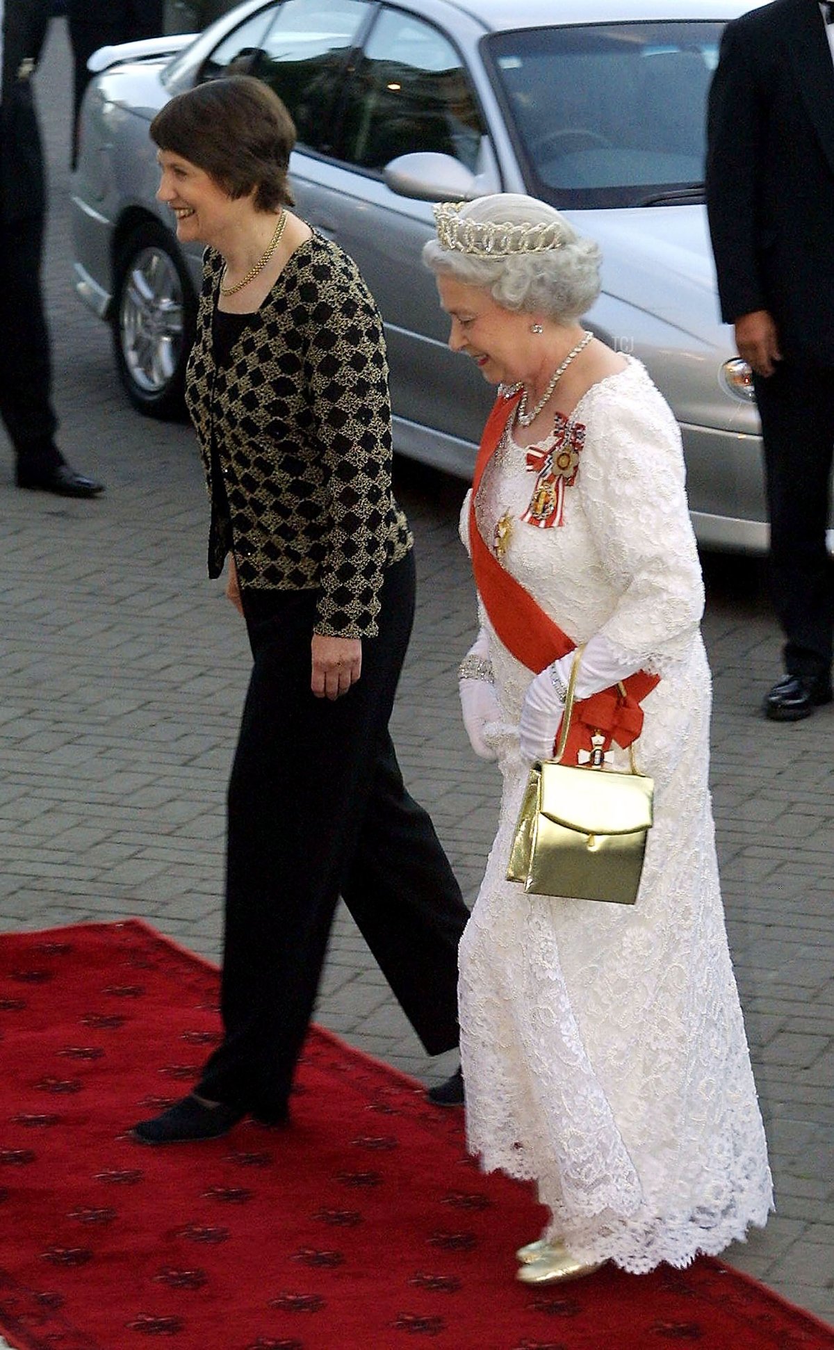 Britains Queen Elizabeth II (R) and New Zealand Prime Minister Helen Clark arrive for a State Dinner at the Banquet Hall in the Parliament House February 25, 2002 in Wellington, New Zealand