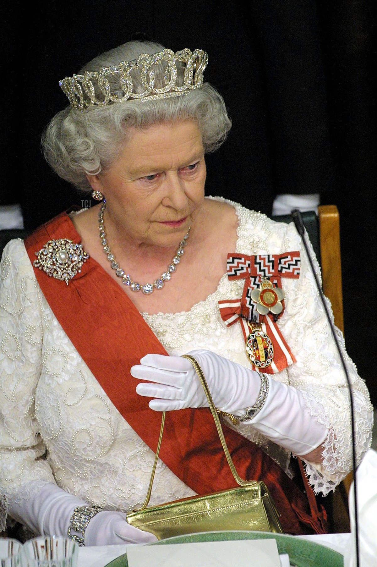 Britains Queen Elizabeth II takes her seat during a State Dinner held at the Banquet Hall in the Parliament House February 25, 2002 in Wellington, New Zealand
