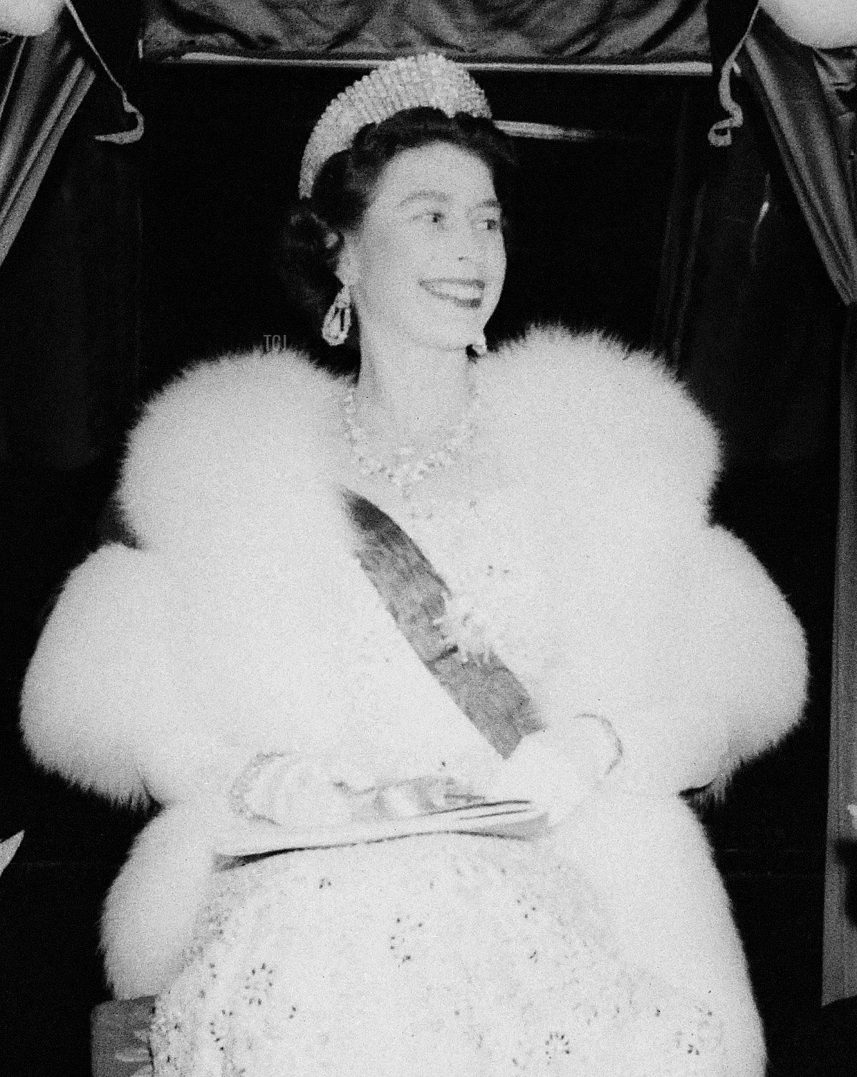 Queen Elizabeth II flanked the Duke of Edinburgh (L) and French President Rene Coty seats aboard the "Borde Fretigny" boat in Paris during a state visit in France on April 10, 1957