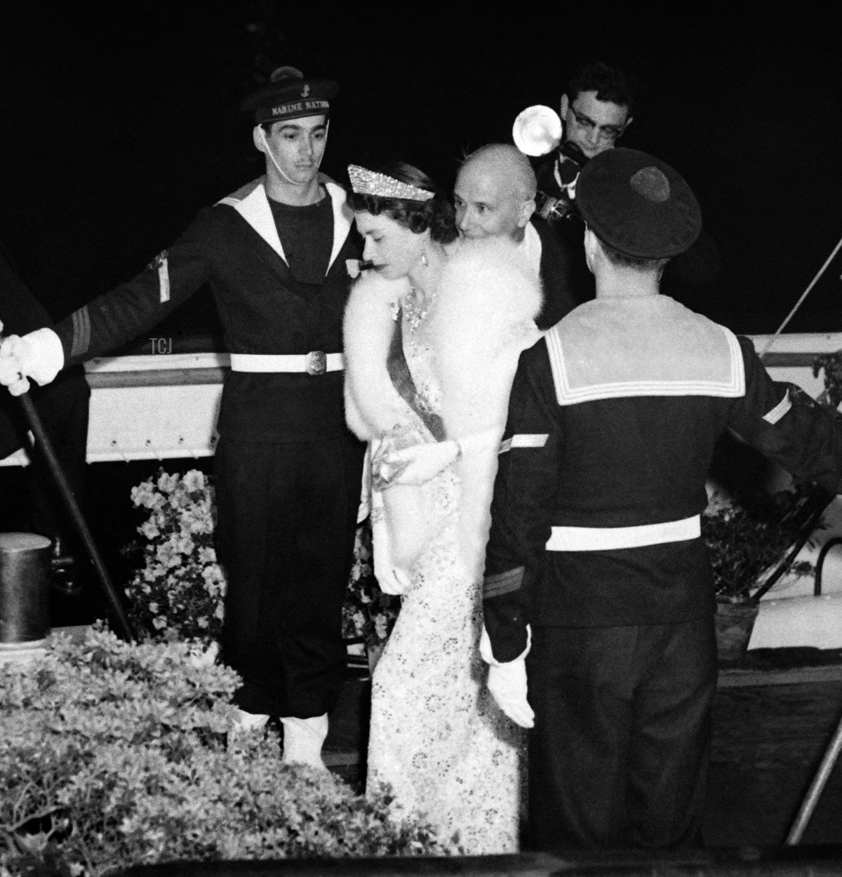 Queen Elizabeth II followed by French President Rene Coty (C) go aboard the "Borde Fretigny" boat in Paris during a state visit in France on April 10, 1957