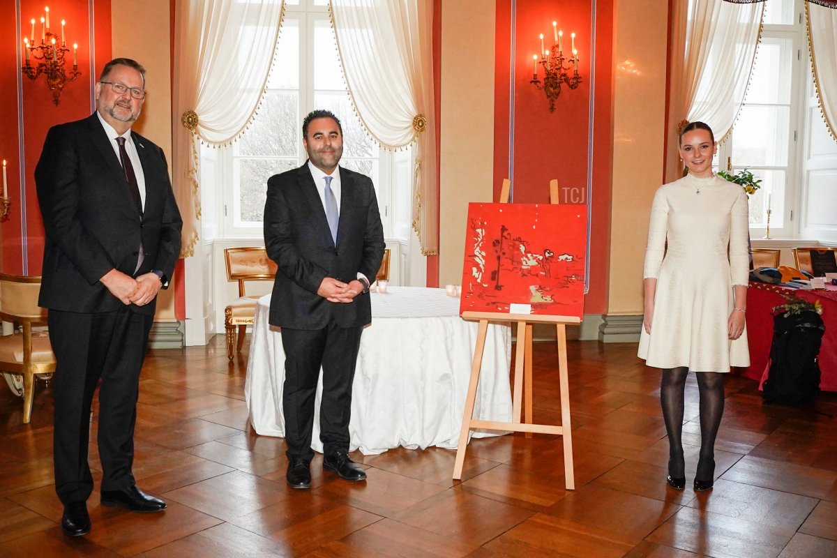 Princess Ingrid Alexandra of Norway (R) poses with the President of the Norwegian Parliament Masud Gharahkhani (C) and First Vice President Svein Harberg next to the painting "Missing Color" by Norwegian artist Astrid Nondal, The Parliament's official gift to the Princess on her 18th birthday, in Oslo on January 21, 2022