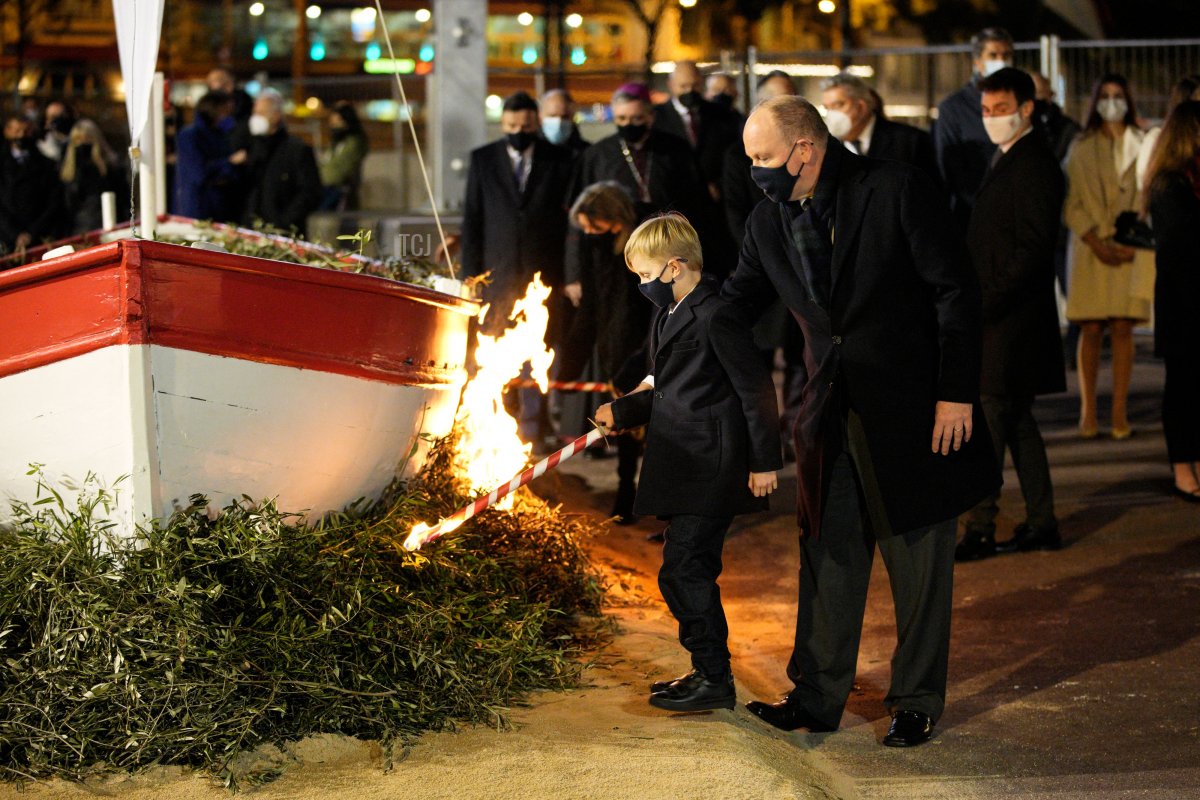 Prince Jacques (L) and Prince Albert II of Monaco set alight a sailboat during the Sainte Devote festivities, in Monaco on January 26, 2022