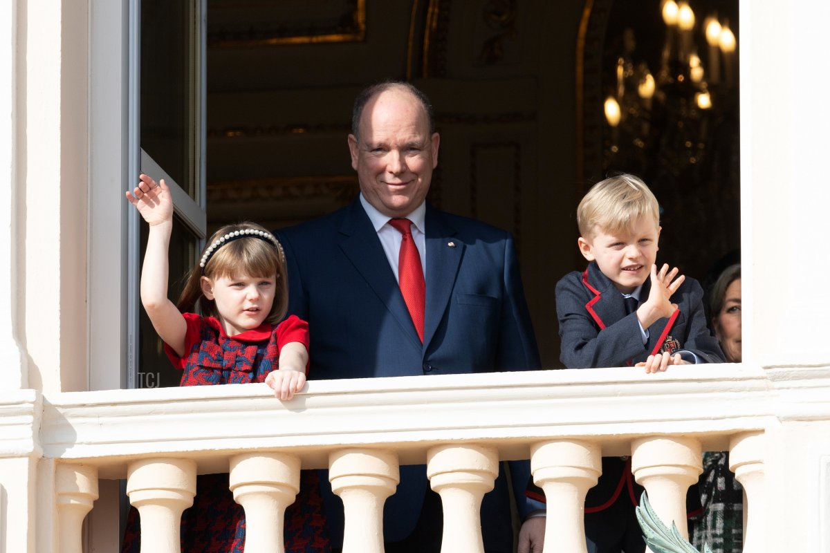 Princess Gabriella of Monaco, Prince Albert II of Monaco and Prince Jacques of Monaco greet the crowd from the palace balcony during the Sainte Devote Ceremony on January 27, 2022 in Monaco