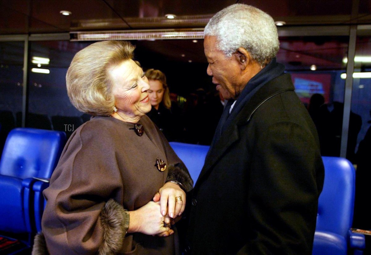 Queen Beatrix (L) welcomes former South African president Nelson Mandela 01 February 2002, at the Arene in Amsterdam, where a party will take place for the royal couple to get married tomorrow