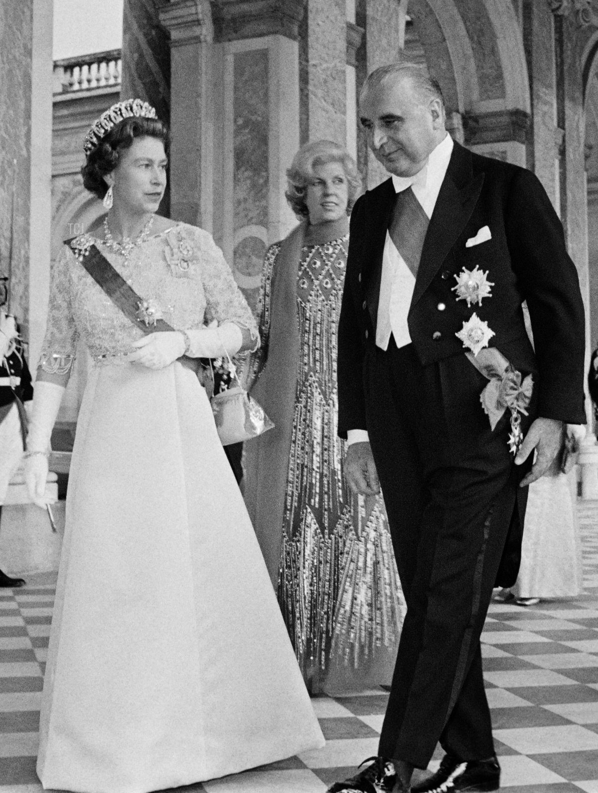 Queen Elizabeth II (L), Prince Philip, Duke of Edinburgh (background) French President Georges Pompidou (L) and his wife Claude (background) arrive for a state dinner at the Grand Trianon in Versailles on May 15, 1972