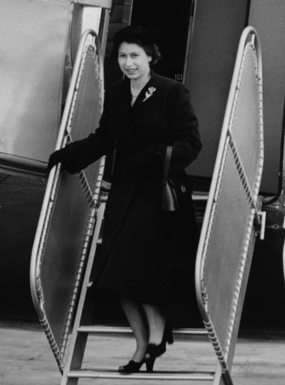 Queen Elizabeth II is saluted by the crew as she leaves her Viking airplane of the King's Flight, London Airport, June 3rd 1952