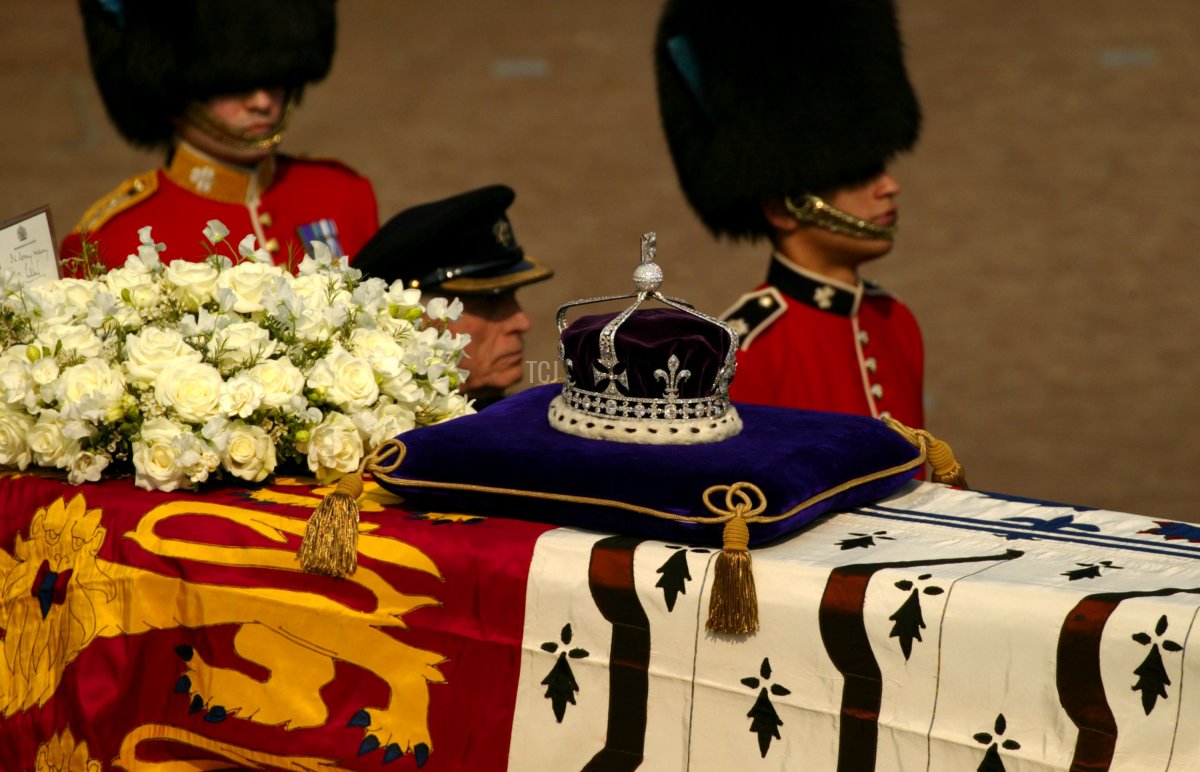 A diamond-encrusted crown bearing the Koh-I-Noor Diamond lies on a coffin bearing the Queen Mother April 5, 2002 as her ceremonial procession makes its way down The Mall in London