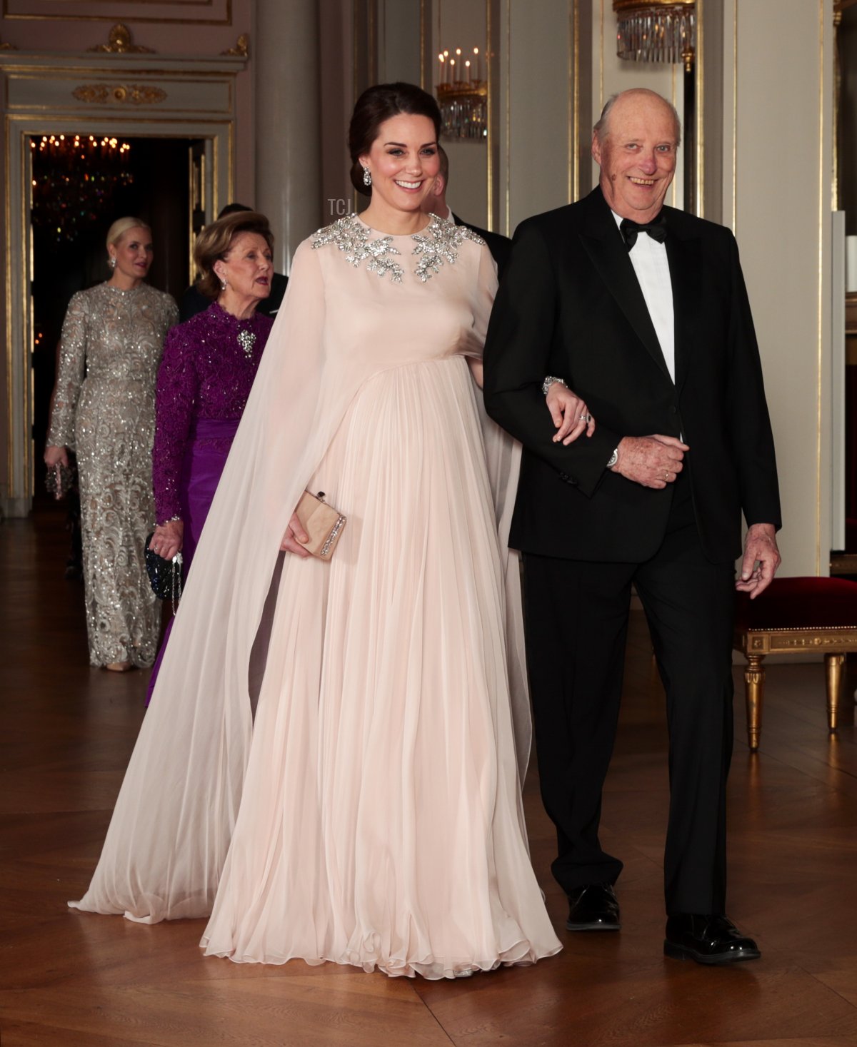 Britain's Catherine, Duchess of Cambridge walks with Norway's King Harald, on their way to the official dinner at the Royal Palace in Oslo, on February 1, 2018, before as part of their visit to Norway
