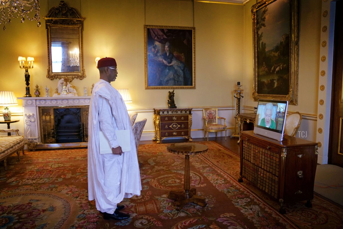 Queen Elizabeth II appears on a screen via videolink from Windsor Castle, where she is in residence, during a virtual audience to receive the Ambassador of Chad, Kedella Younous Hamidi at Buckingham Palace on March 1, 2022 in Windsor, England