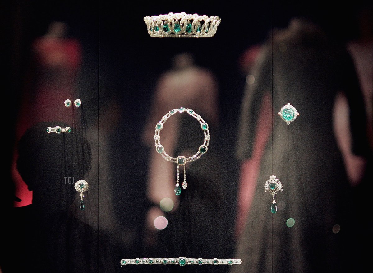 Queen Elizabeth II's dresses are reflected in a glass case displaying The Vladimir Tiara and The Delhi Durbar necklace at Buckingham Palace on July 25, 2006 in London