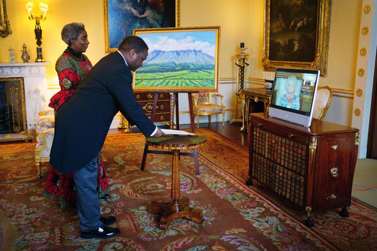 Queen Elizabeth II appears on a screen via videolink from Windsor Castle, where she is in residence, during a virtual audience to receive the High Commissioner of Malawi, Dr. Thomas Bisika (centre), and Mrs Bisika (left), at Buckingham Palace on March 3, 2022 in London, England