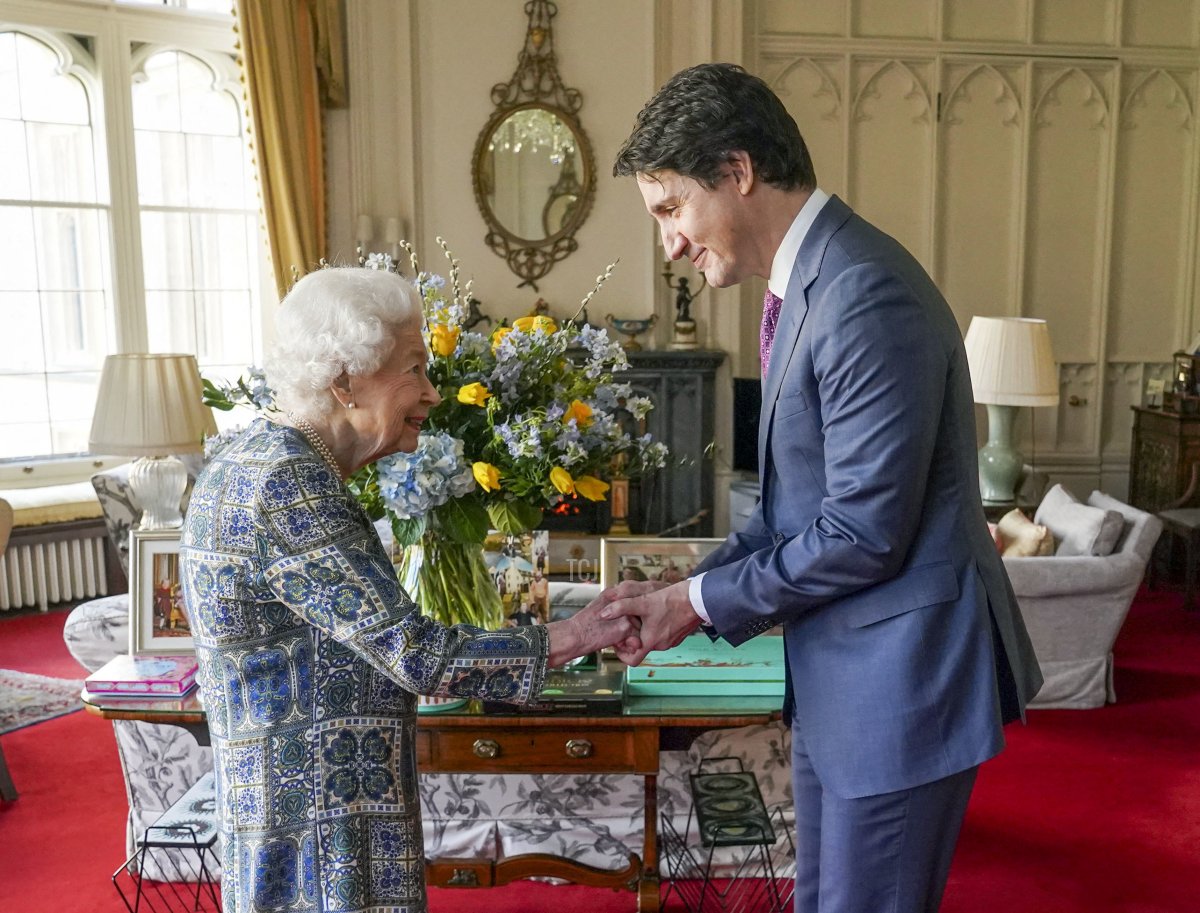 Britain's Queen Elizabeth II (L) shakes hands with Canadian Prime Minister Justin Trudeau as they meet for an audience at the Windsor Castle, Berkshire, on March 7, 2022