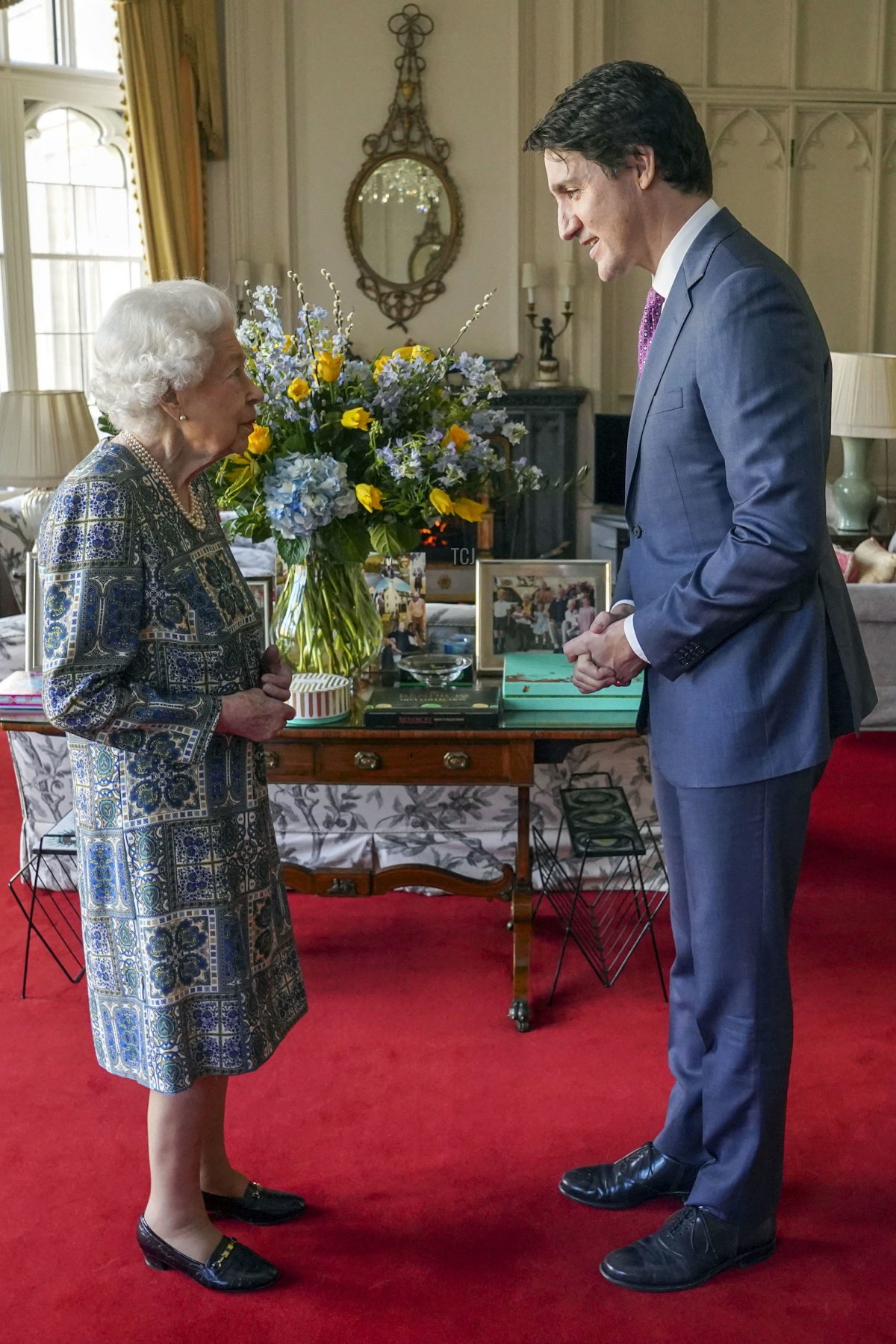 Britain's Queen Elizabeth II (L) speaks with Canadian Prime Minister Justin Trudeau during an audience at the Windsor Castle, Berkshire, on March 7, 2022