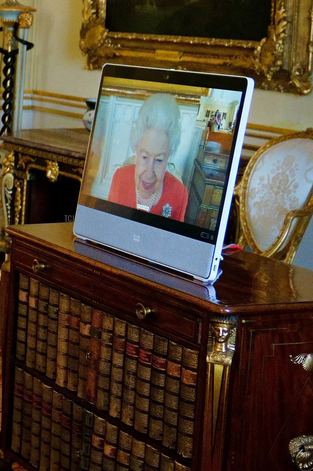 Britain's Queen Elizabeth II (R) appears on a screen via videolink from Windsor Castle, during a virtual audience to receive the High Commissioner of India to the United Kingdom, Gaitri Issar Kumar, at Buckingham Palace in London on March 8, 2022