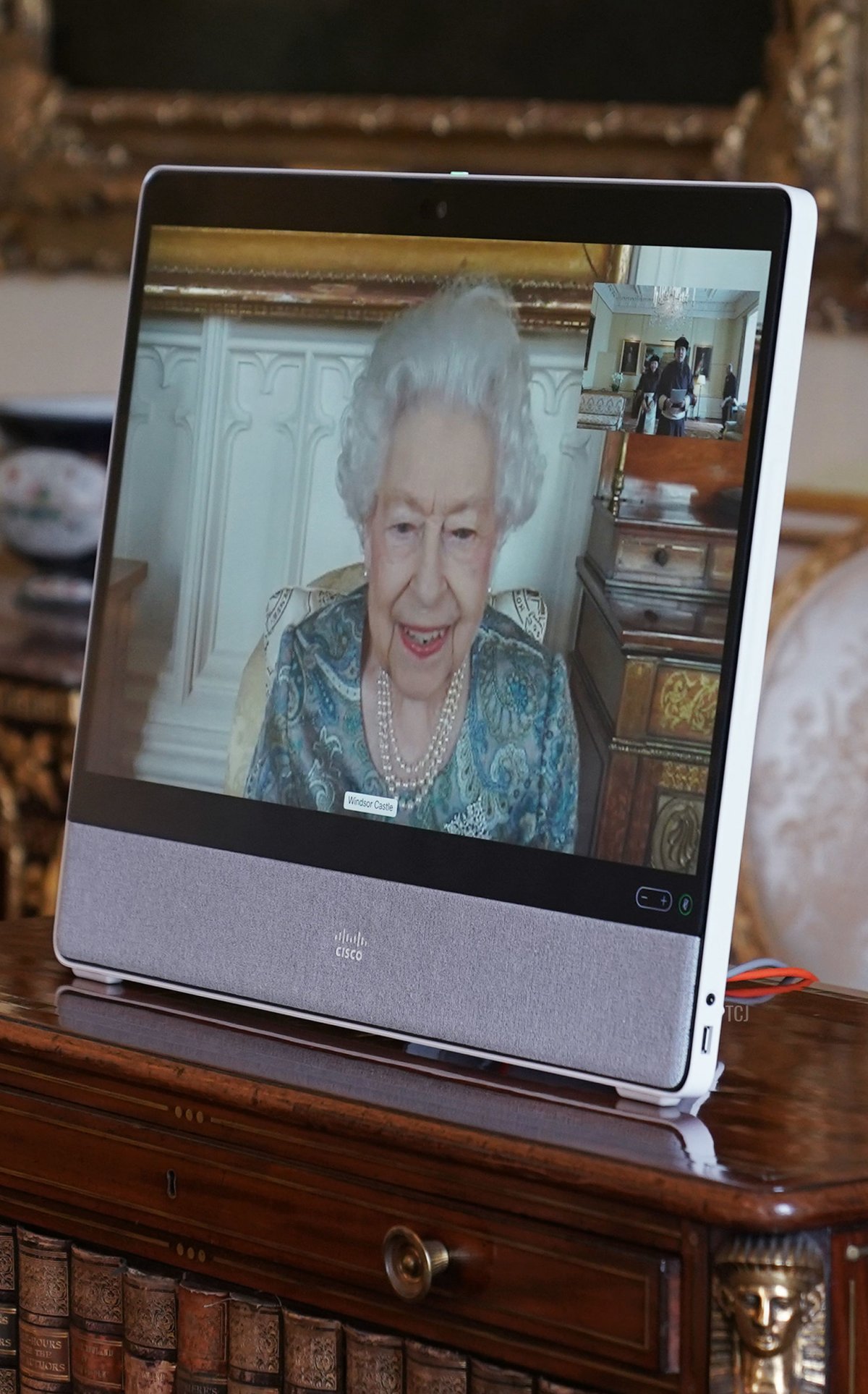 Britain's Queen Elizabeth II appears on a screen via videolink from Windsor Castle, during a virtual audience to receive Mongolia's Ambassador to the United Kingdom, Enkhsukh Battumur (unseen), at Buckingham Palace in London on March 15, 2022