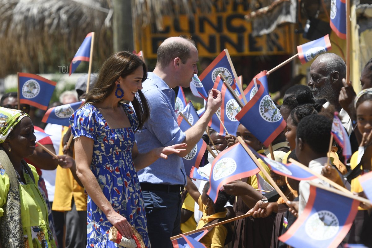 Britain's Prince William (C), Duke of Cambridge and Britain's Catherine (L), Duchess of Cambridge, greet people as they arrive at Hopkins Village, Belize on March 20, 2022